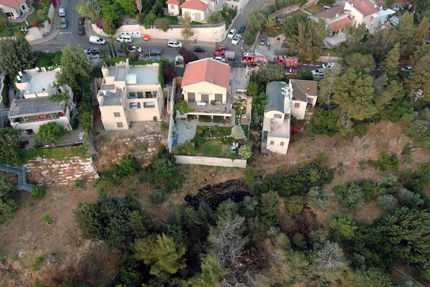 A hole in the ground where a rocket launched by Hamas landed in the outskirts of Jerusalem.