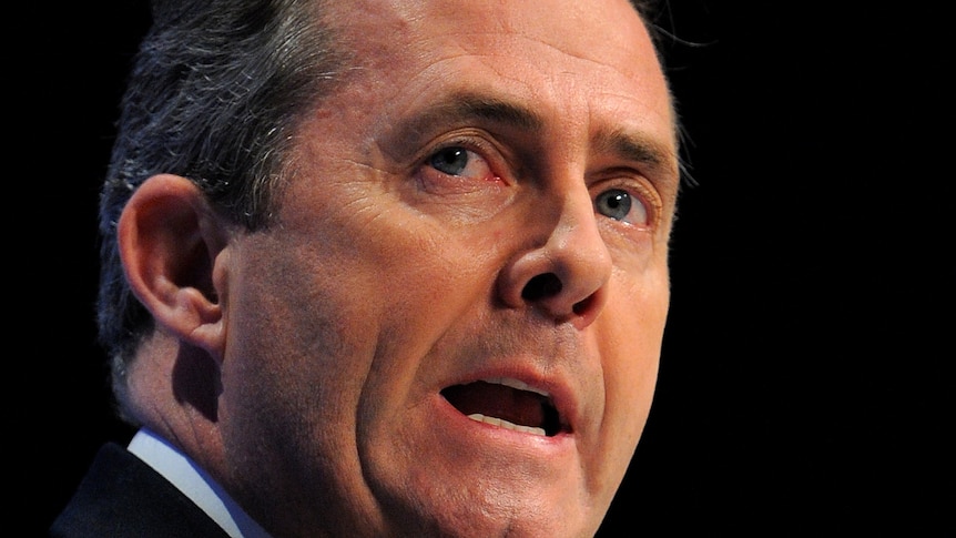 British Secretary of State for Defence Liam Fox addresses delegates during the final day of the Conservative Party Conference