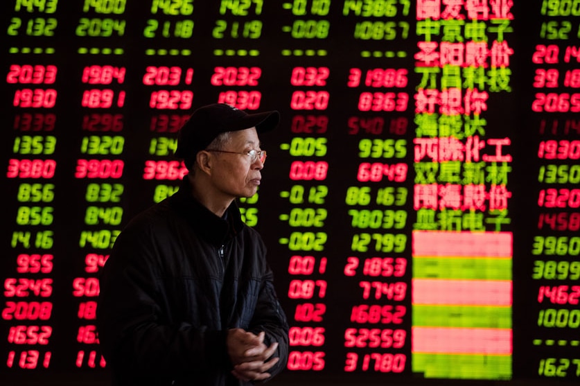An investor observes stock market at a stock exchange corporation