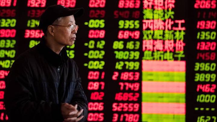 An investor observes stock market at a stock exchange corporation