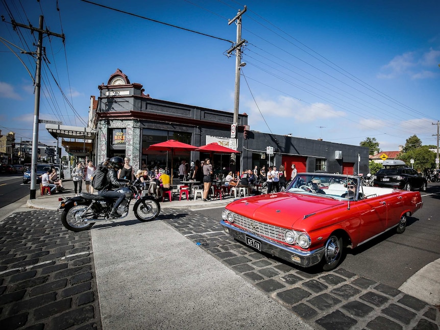 The Old Bike Shop cafe in Melbourne with a red vintage car outside
