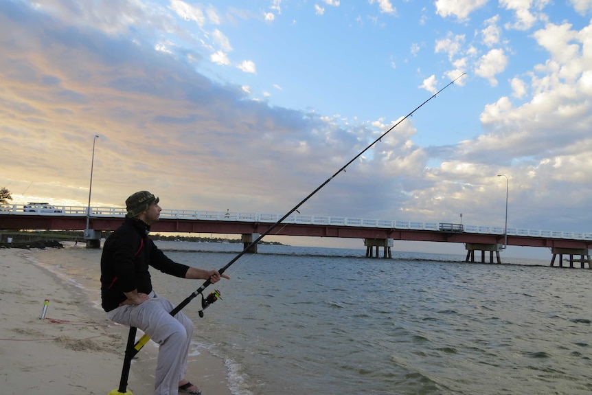 Demis Lambert fishing by the Bribie Island Bridge