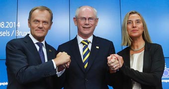 CUSTOM EU appointments Newly elected European Council President Donald Tusk (L) of Poland and newly elected European High Representative for Foreign Affairs Federica Mogherini (R) of Italy are congratulated by outgoing European Council President Herman Van Rompuy