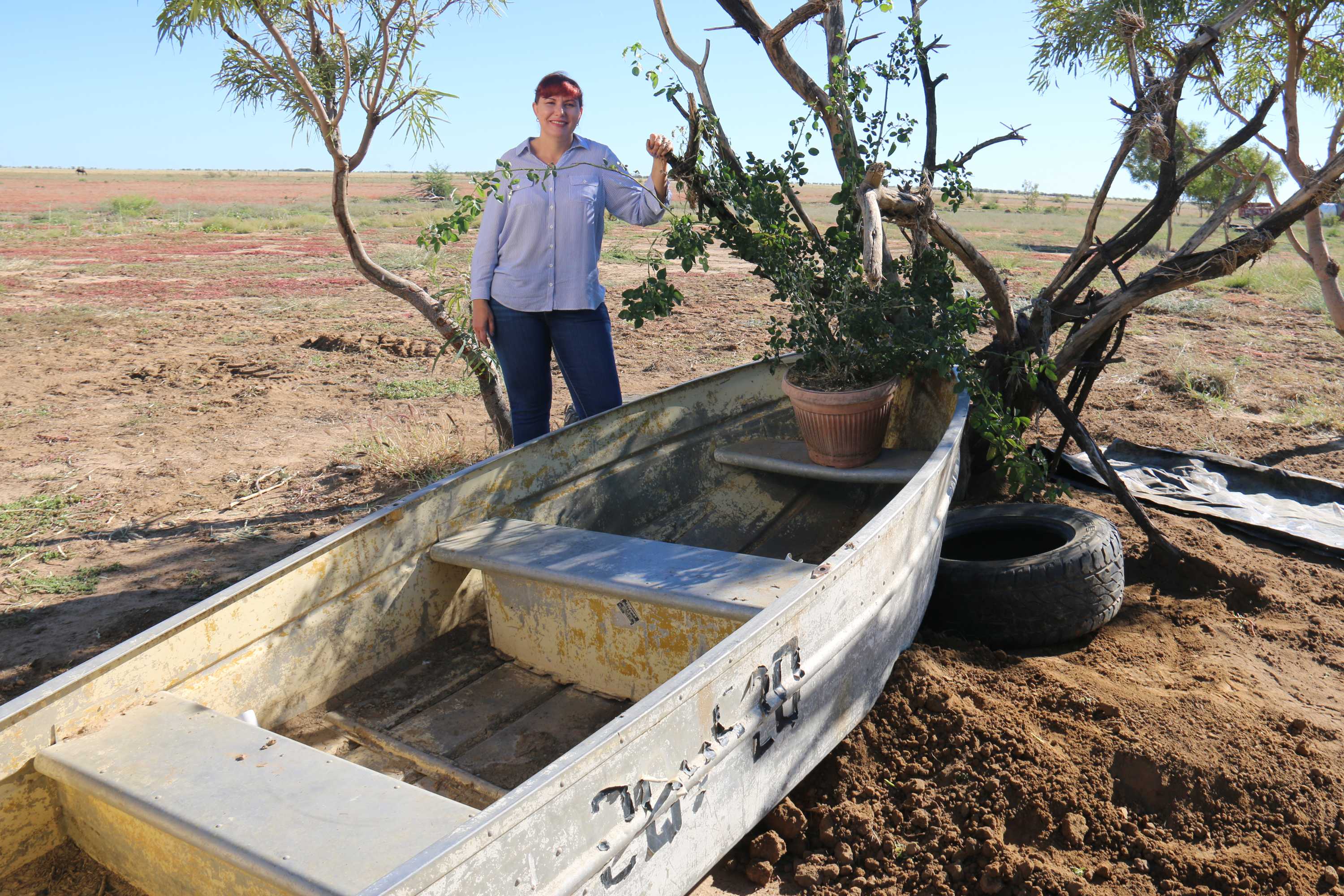 Kylie sits on the boat that saved her husband's life.