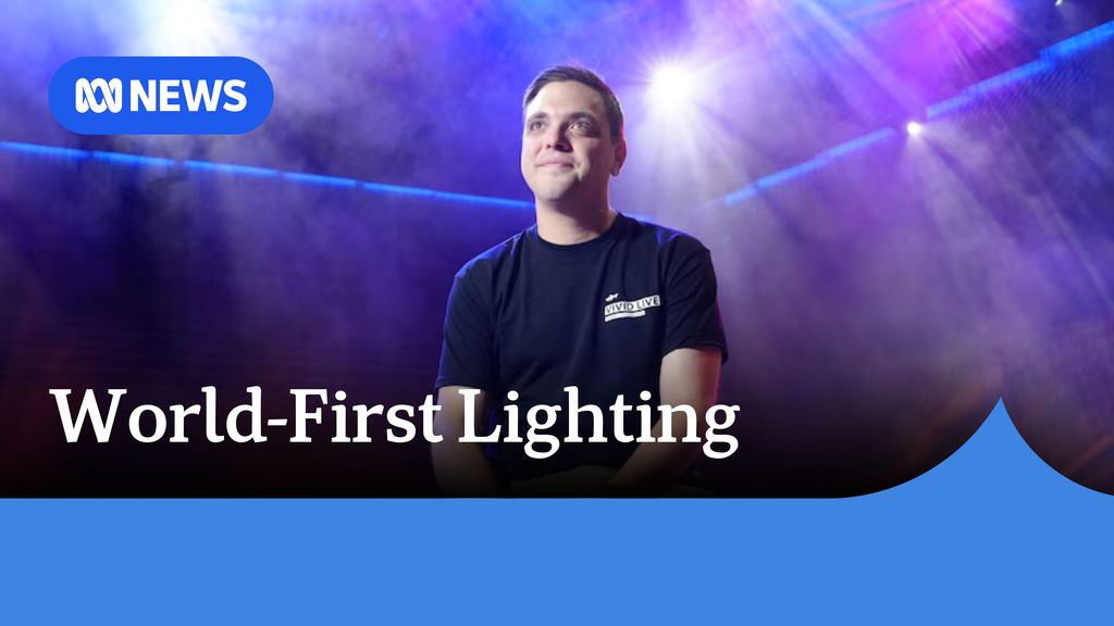 World_First Lighting: A man with a dark t-shirt with a satisfie expression and lighting around him.