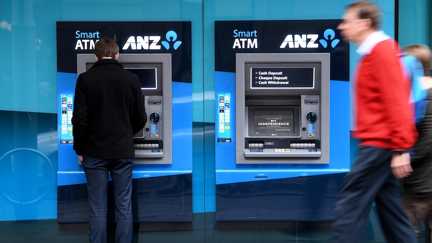 People walk past ANZ atms