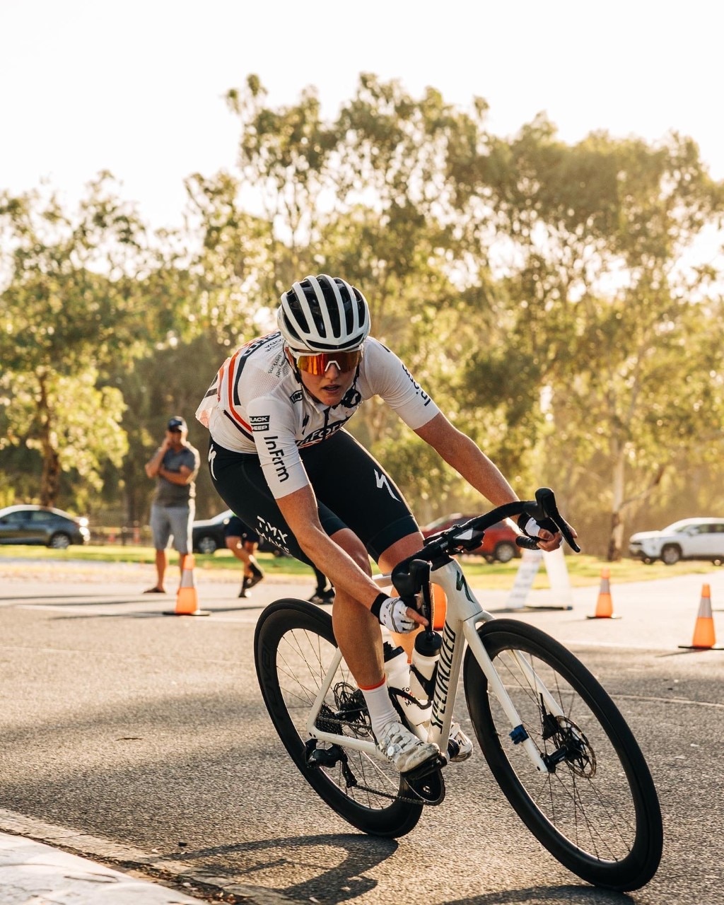 A young female cyclist concentrates on a bike during a race. 