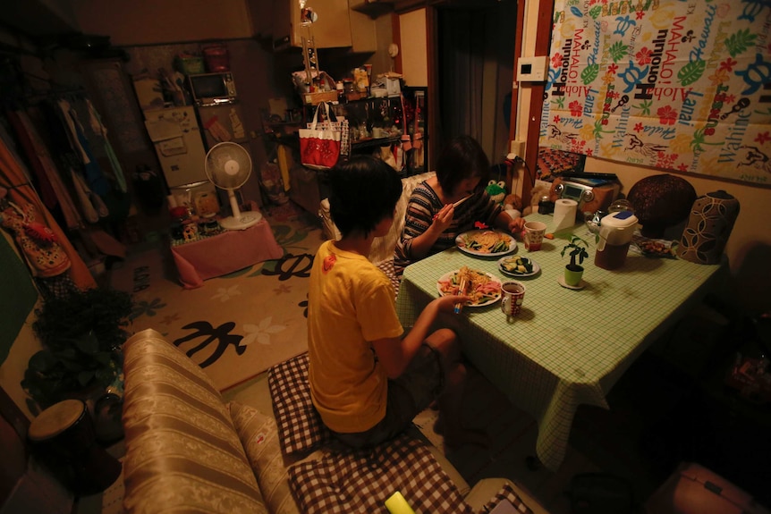 Japanese single mother and child eating in home