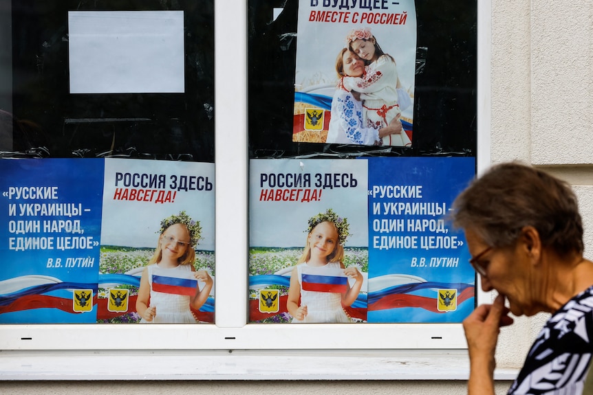 Posters promoting Russia are on display in Kherson.