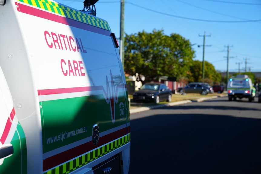 A St John WA vehicle with a 'critical care' label on the side, parked outside a crime scene.