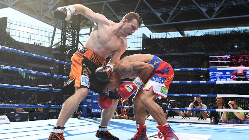 Jeff Horn looks to punch a crouching Manny Pacquiao