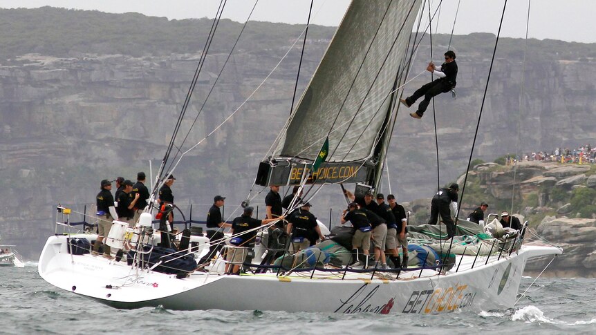 A crew member descends from the mast of Lahana during the Sydney to Hobart yacht race.