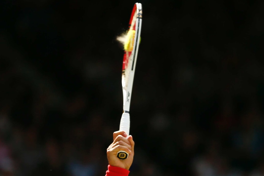 A tennis ball gets compressed against a racquet.