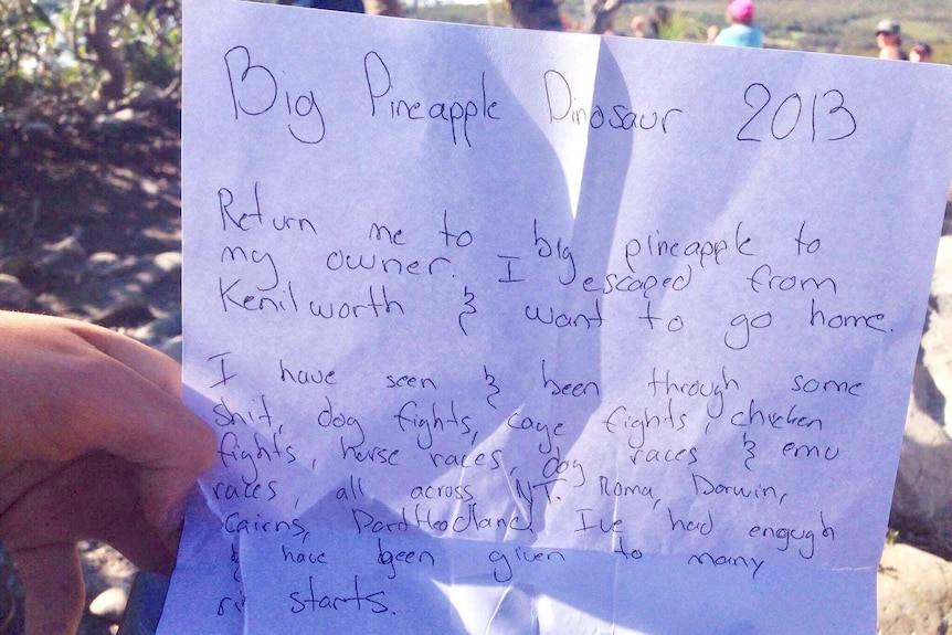 note attached to a dinosaur statue which was stolen