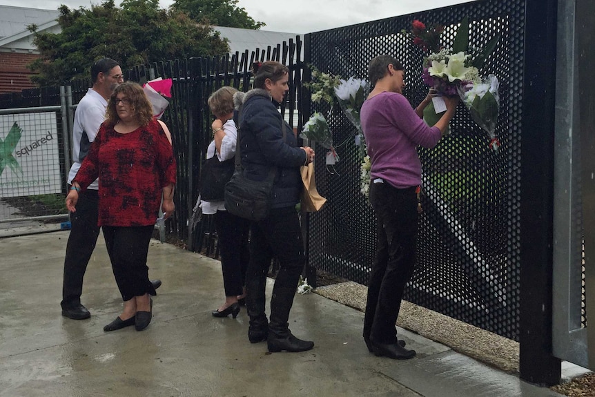 People lay flowers at former asylum