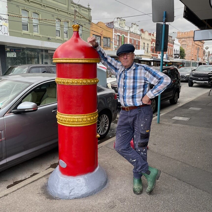Mick Slocum stands with a freshly painted post box