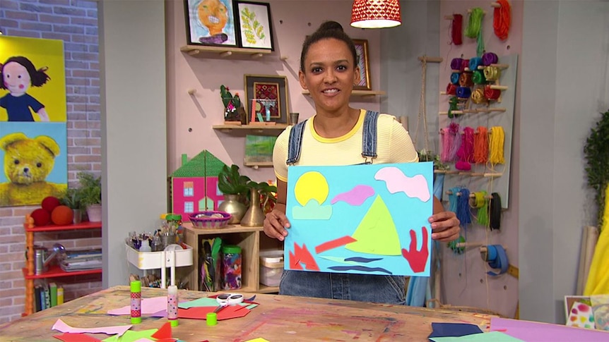 Zindzi holding up her artwork