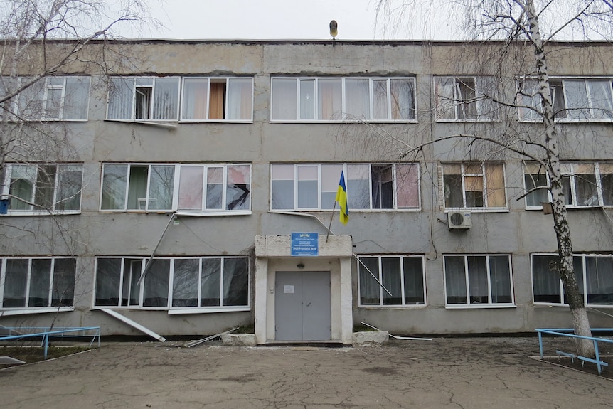 A view shows a school building, which locals said was damaged by recent shelling.