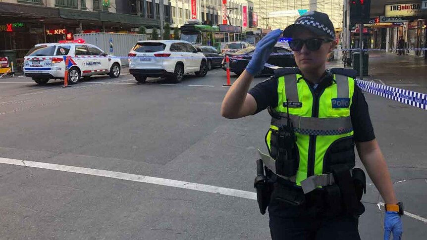 A police officer at the scene of an incident near Flinders Street Station in Melbourne.