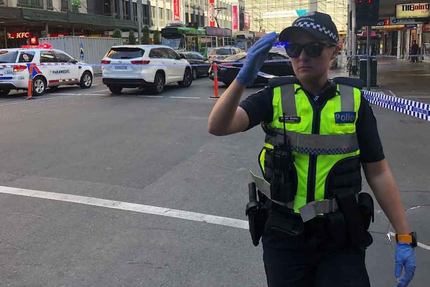 A police officer at the scene of an incident near Flinders Street Station in Melbourne.