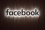 Facebook's company logo appears on a wall at its offices in New York.