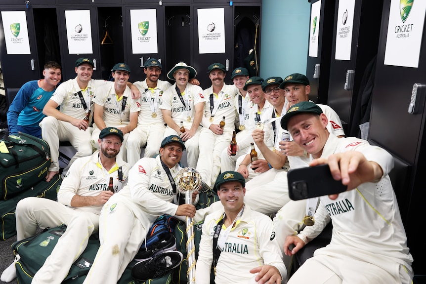 The Australian cricket team gathers in the change rooms as Marnus Labuschagne takes a selfie of the group