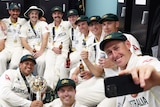 The Australian cricket team gathers in the change rooms as Marnus Labuschagne takes a selfie of the group