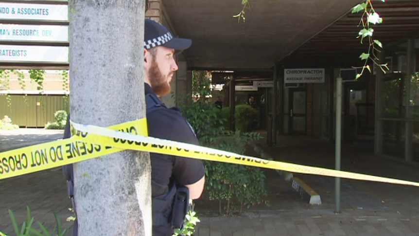 Police officer guards a North Adelaide explosion scene.