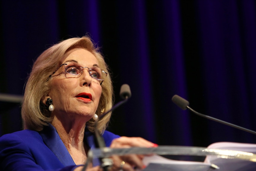 Ita Buttrose stands at a lecturn