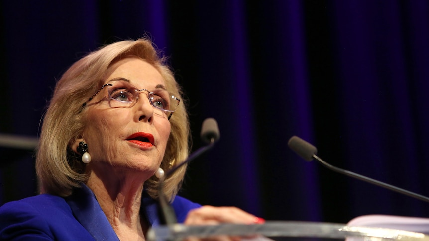 Ita Buttrose stands at a lecturn