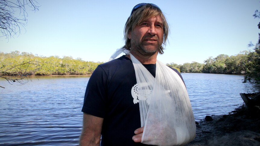 Craig McDougall was bitten by a small shark while stand up paddling near his home at Pelican Waters, on the Sunshine Coast.
