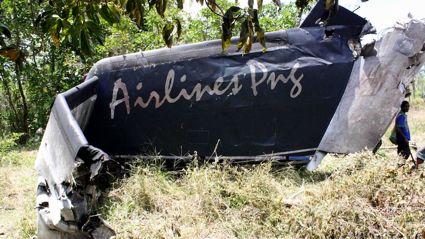 The remains of an Airlines PNG Dash 8 plane is pictured near Madang in Papua New Guinea on Friday, October 14, 2011.