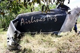 The remains of an Airlines PNG Dash 8 plane is pictured near Madang in Papua New Guinea on Friday, October 14, 2011.