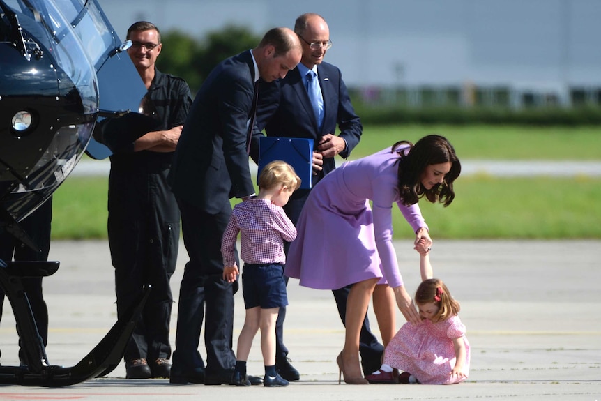The Duchess of Cambridge attempts to help Princess Charlotte off the tarmac and back onto her feet.