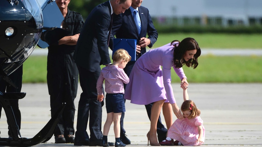 The Duchess of Cambridge attempts to help Princess Charlotte off the tarmac and back onto her feet.