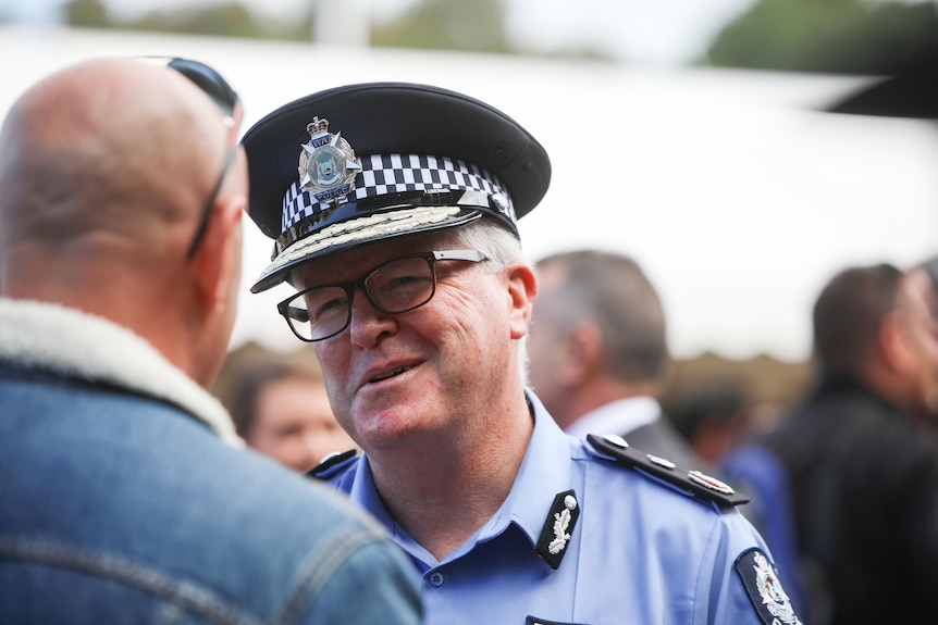 Police Commissioner Chris Dawson speaking to a man.