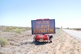 An electric sign on the side of road reading major event Exmouth