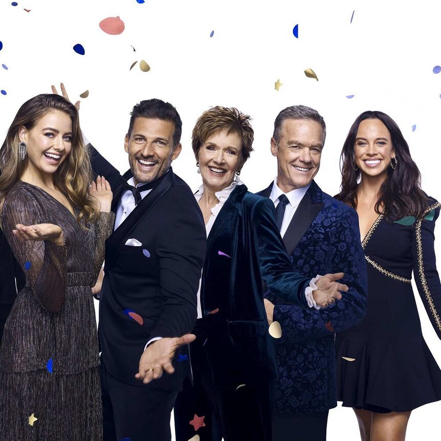 Neighbours stars are dressed in formal wear as confetti falls around them.