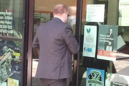 Detectives outside Craig Thomson's office