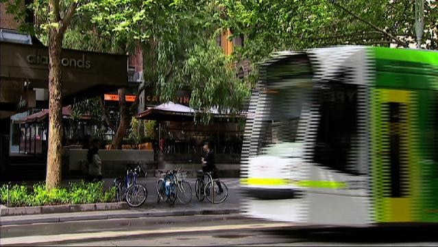 Tram moves along Melbourne street