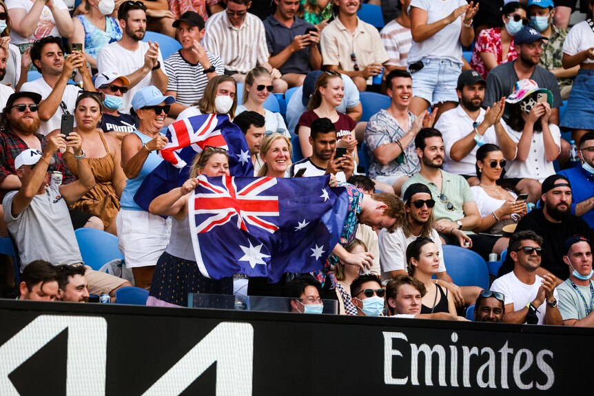 Australian fans hold a flag at the Australian Open