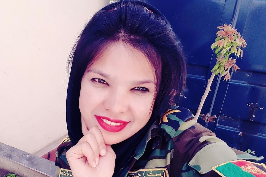 Woman smiling in selfie, in Defense uniform