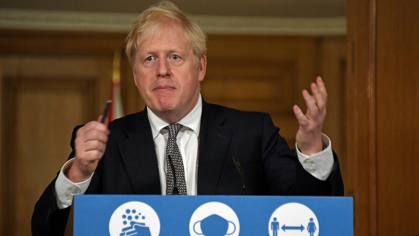 British Prime Minister Boris Johnson gestures as he speaks at a lectern