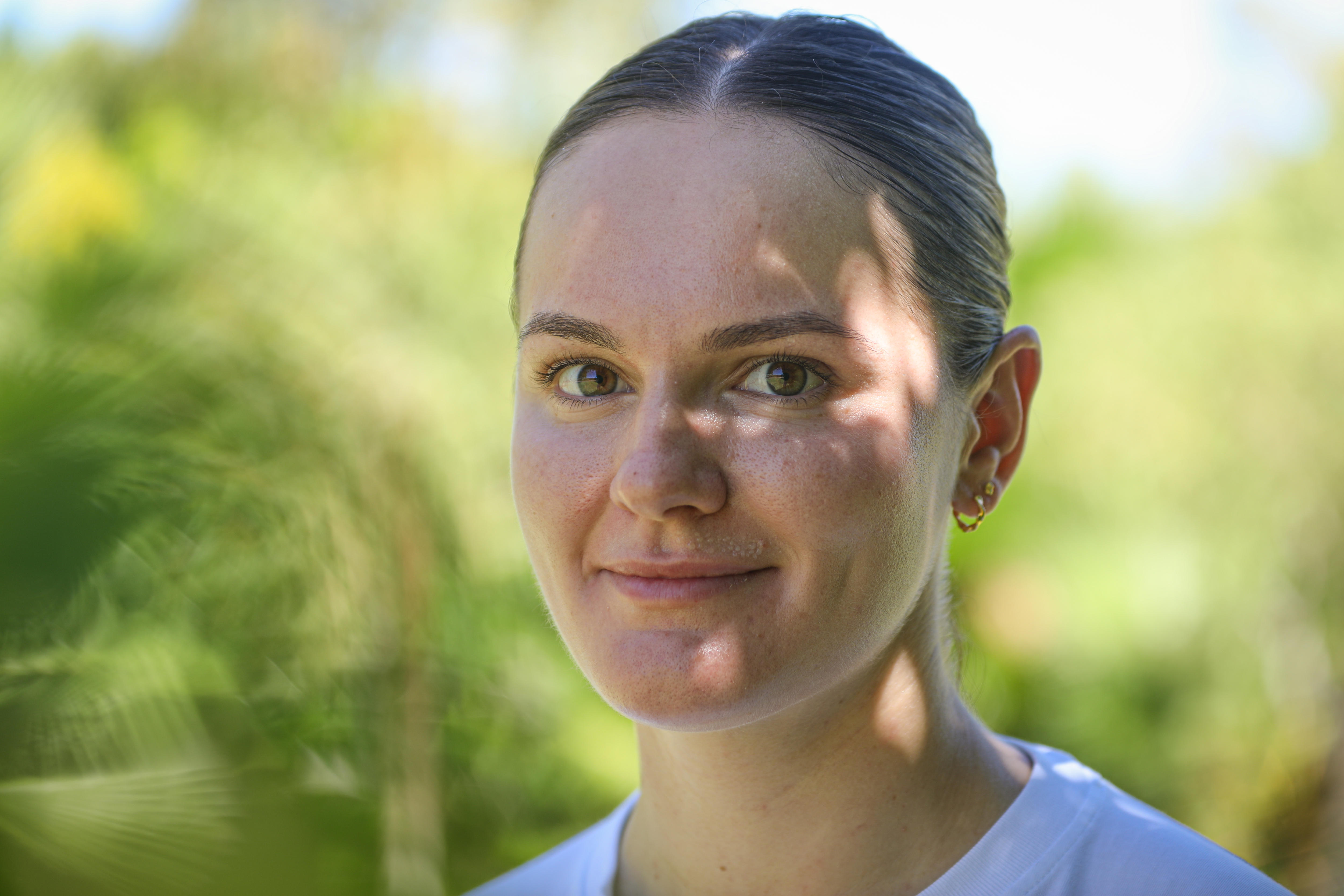 A close-up of a young woman smiling softly