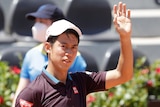 Japan's Kei Nishikori waves after winning his match against Italy's Fabio Fognini at the Italian Open tennis tournament in Rome.