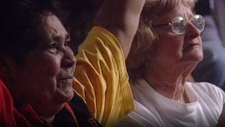 Photo of two women cheering at a sports match
