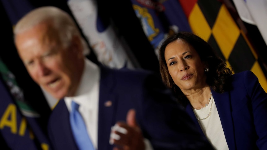 Democratic vice presidential candidate Senator Kamala Harris listens as her running mate Joe Biden speaks