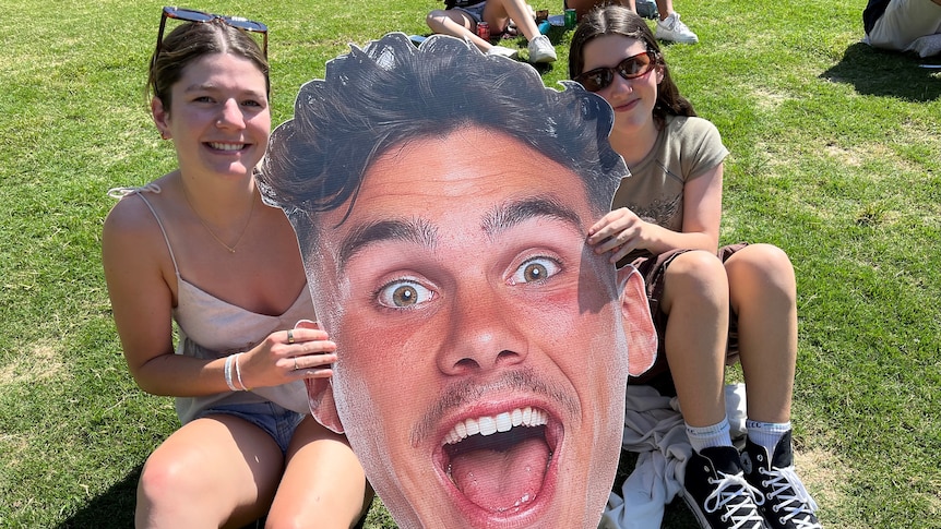 Harriet Alexander-Bates and Annie Simpson hold up a Broncos sign