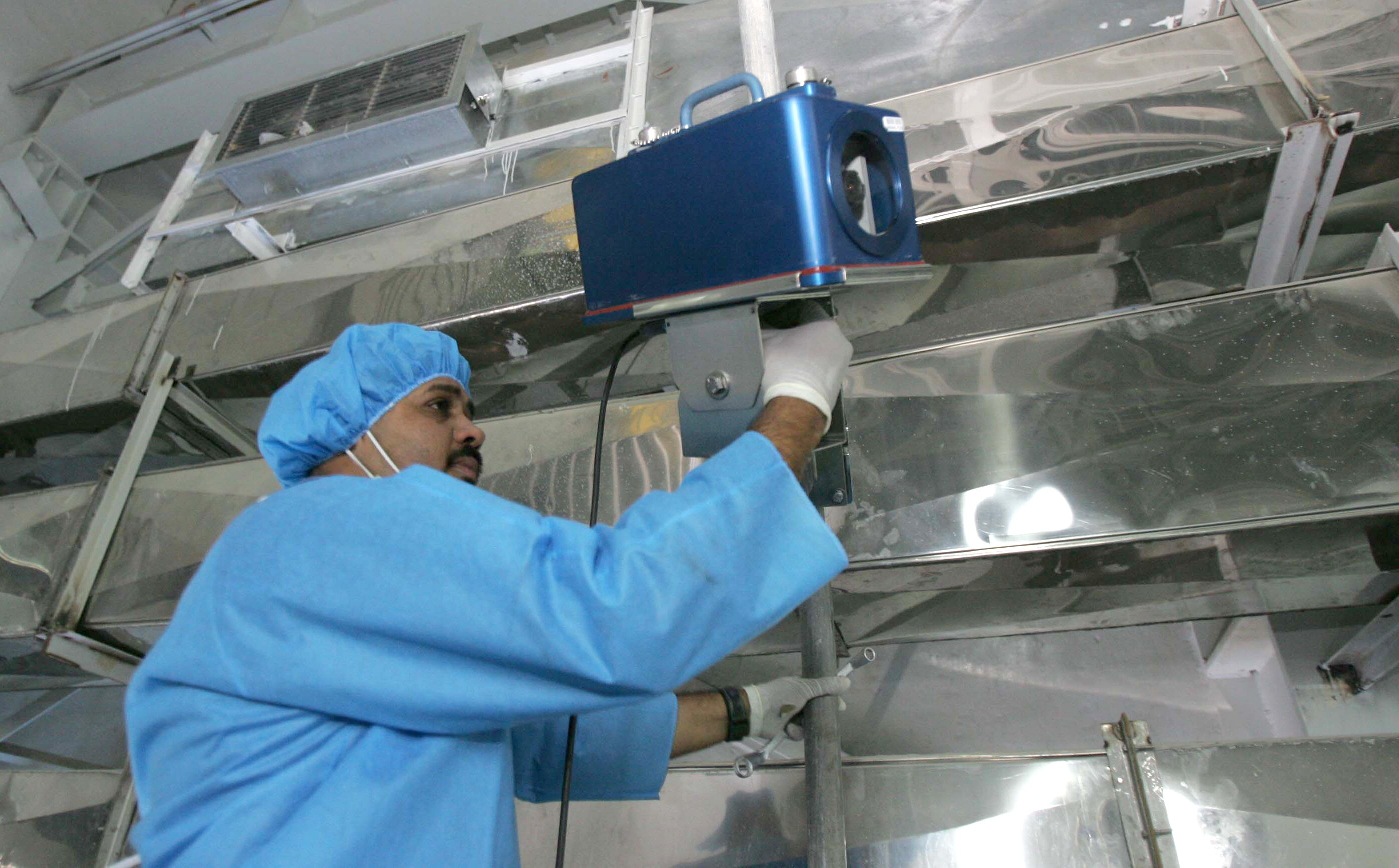A man holding a large camera.