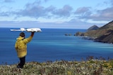 Ecologist  Jarrod Hodgson launches an unmanned aircraft.
